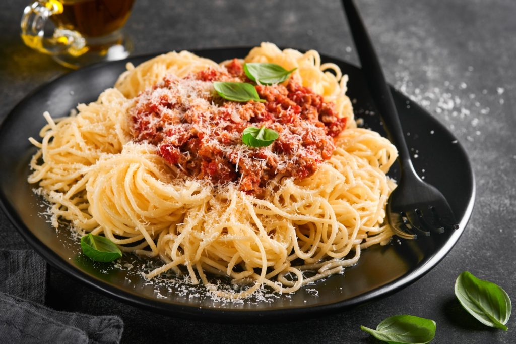 Classic spaghetti pasta Bolognese. Tasty appetizing italian spaghetti with bolognese sauce, tomato